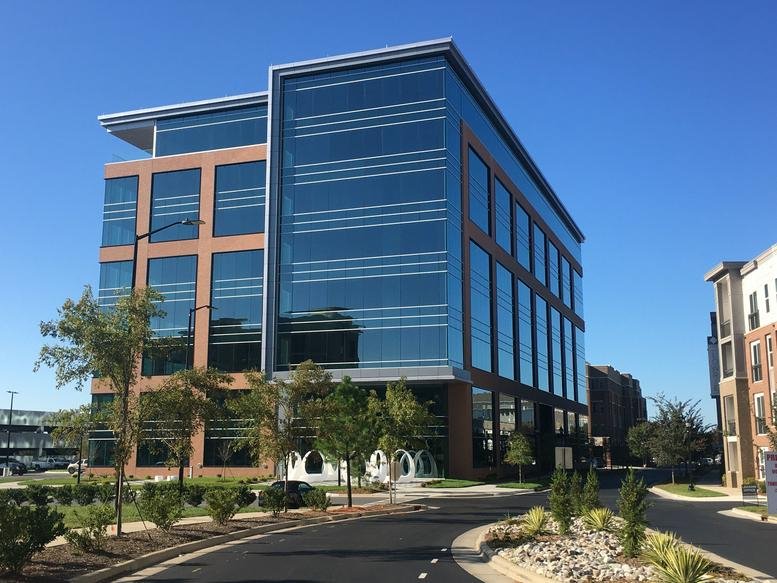 Exterior view of the glass and brick facade at 3540 Toringdon Way, Suite 200, Charlotte.