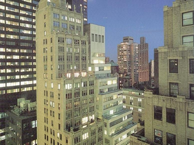 Exterior view of the classic stone facade at 369 Lexington Avenue during twilight.