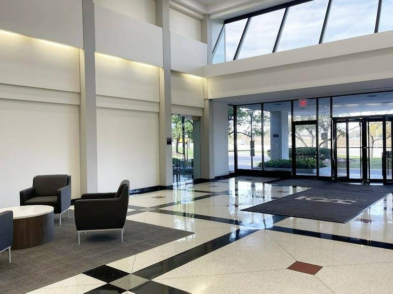 Bright lobby at 3701 Algonquin Road, Suite 300 with polished floors and a wall of windows.