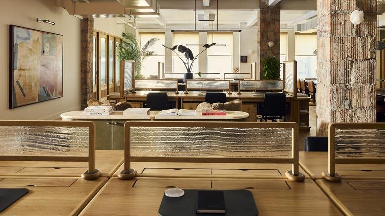 Spacious co-working area at 387 Park Avenue South, Manhattan, New York City with wooden desks and artistic dividers.