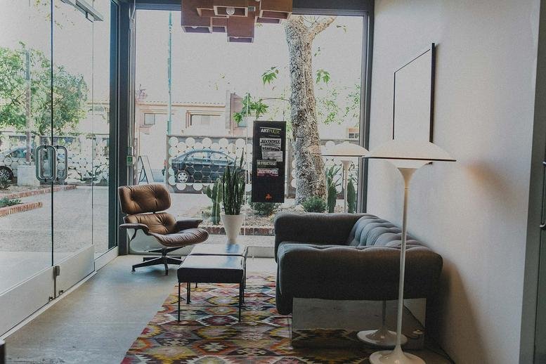 Lounge area at 30th Street, North Park, San Diego, California with a leather chair and colorful rug.