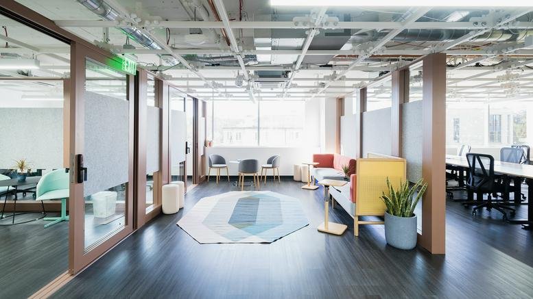 Modern reception area at 4 West 4th Avenue featuring a glass entrance and colorful seating.