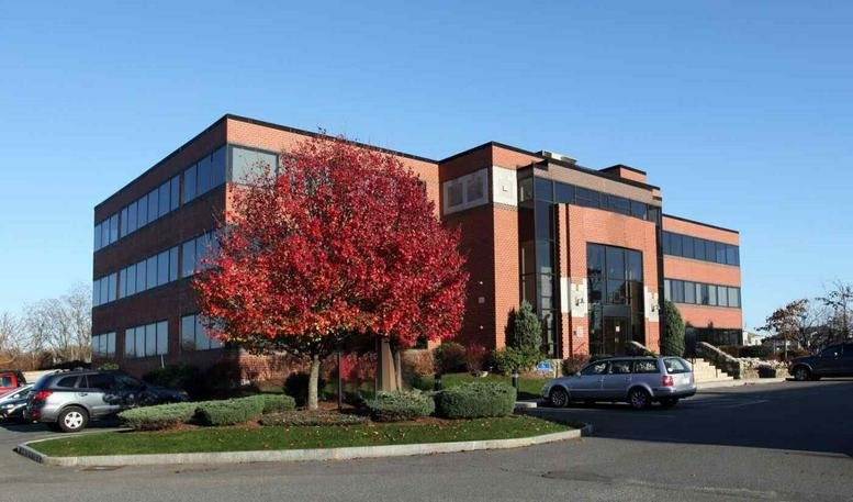 Exterior view of the brick facade and autumn trees at 40 Tioga Way, Marblehead, Massachusetts.