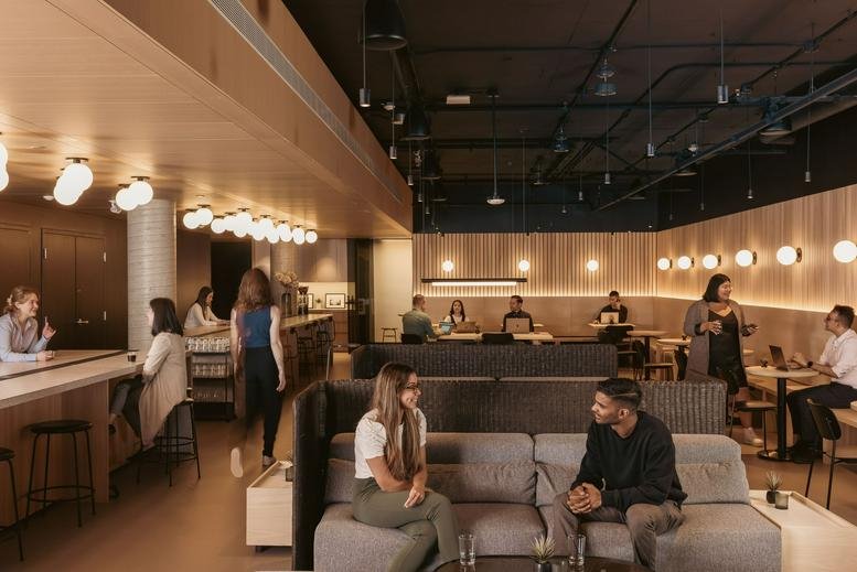Spacious communal lounge at 400, 22 East 5th Avenue with warm lighting and booth seating.