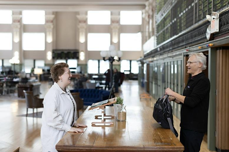 Grand historic lobby at Minneapolis Grain Exchange with high ceilings and a wooden reception desk.