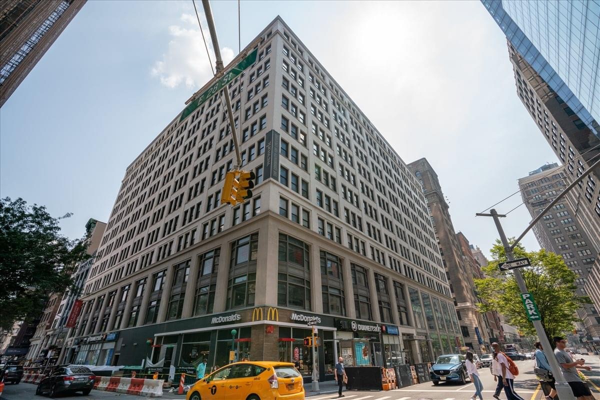 Exterior view of the historic stone and glass facade building at 401 Park Avenue South.