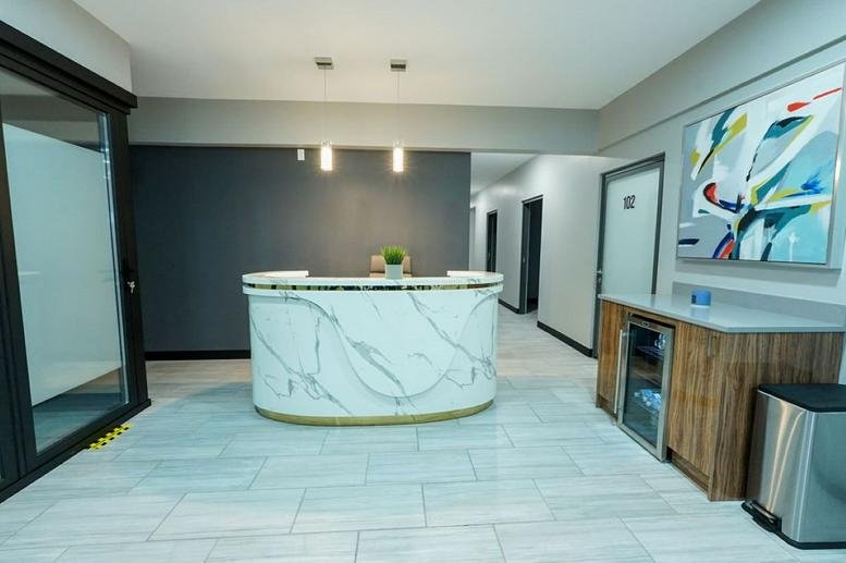 Modern marble reception desk at 404 Airport Freeway, Suite 100, Bedford (New Hampshire).