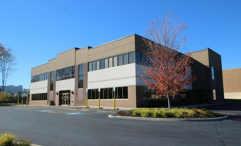 Exterior view of the brick and glass office building at 4050 West Ridge Road, First Floor, Rochester.