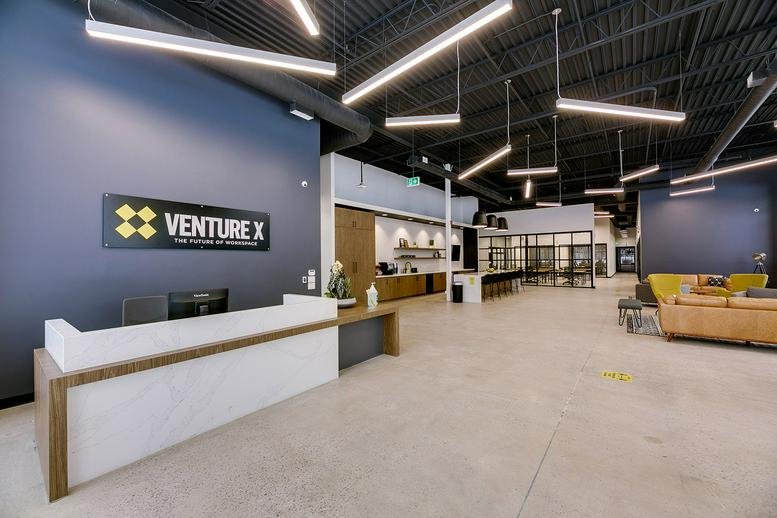 Venture X reception area at 407 Iroquois Shore Road, Unit 8, Oakville, Ontario featuring a stone front desk.