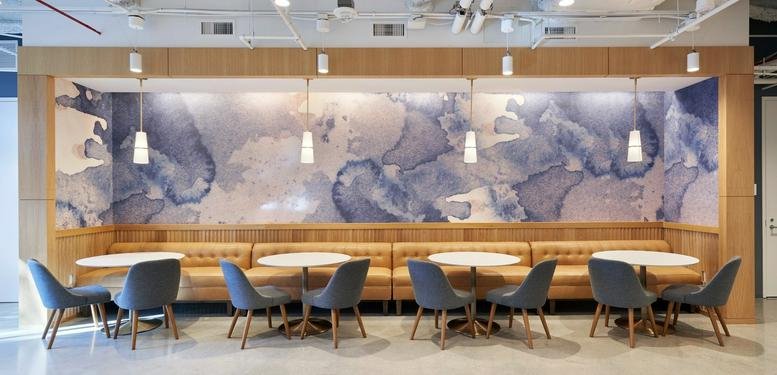 Spacious communal lounge at 407 North Maple Drive, Ground Floor featuring abstract mural and booth seating.