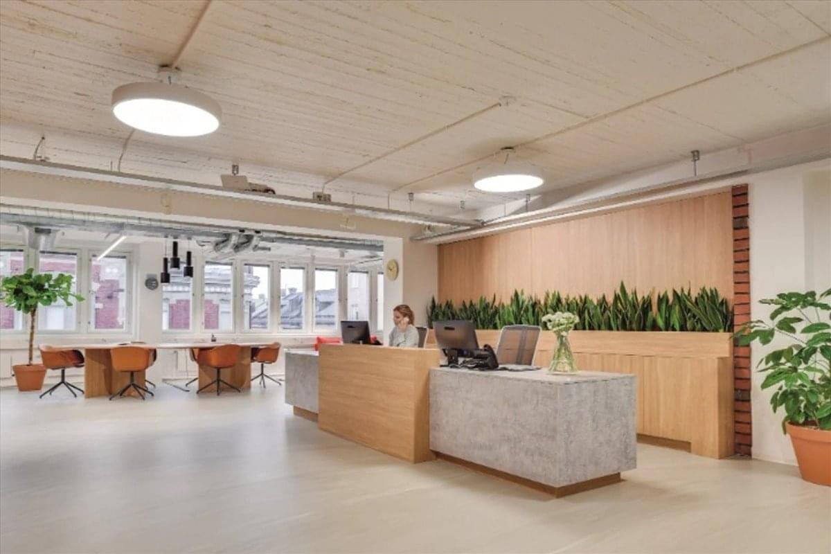Spacious reception area with wood and stone desks at 409 13th Street, Oakland, California.