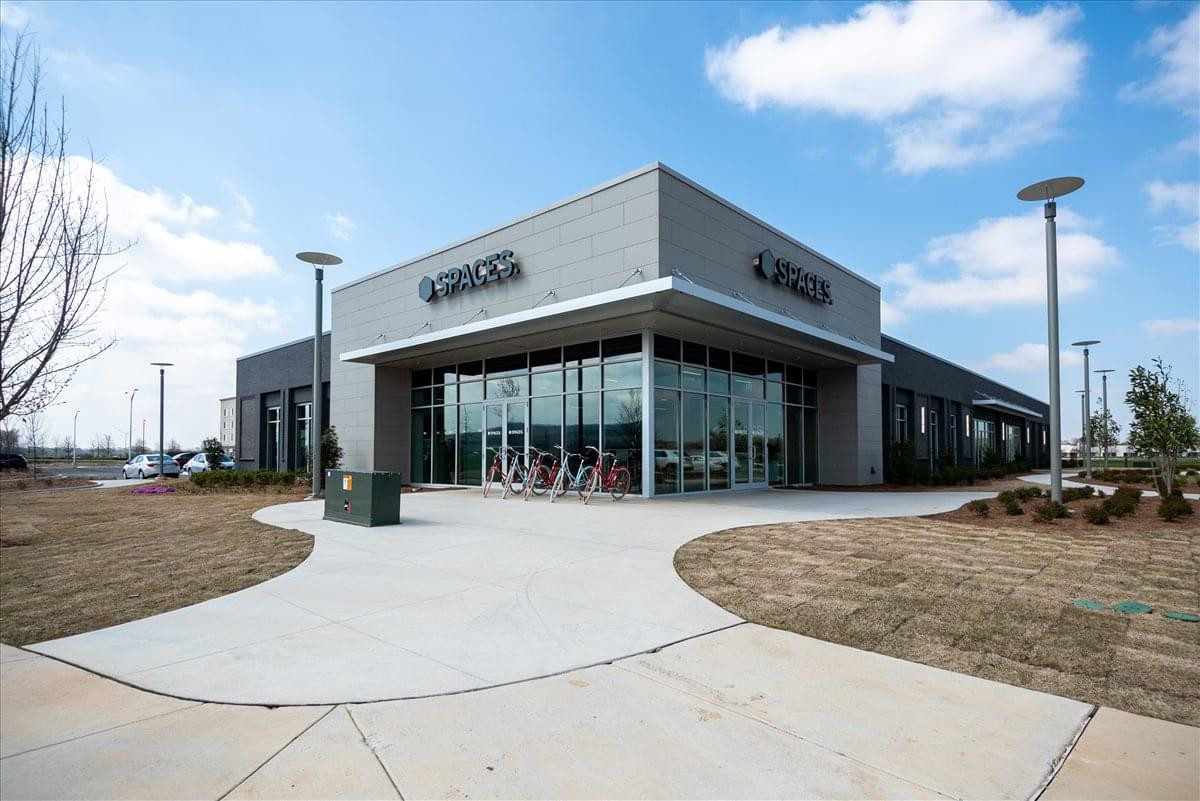 Modern single-story exterior of Redstone Gateway at 4100 Market St under a bright blue sky.
