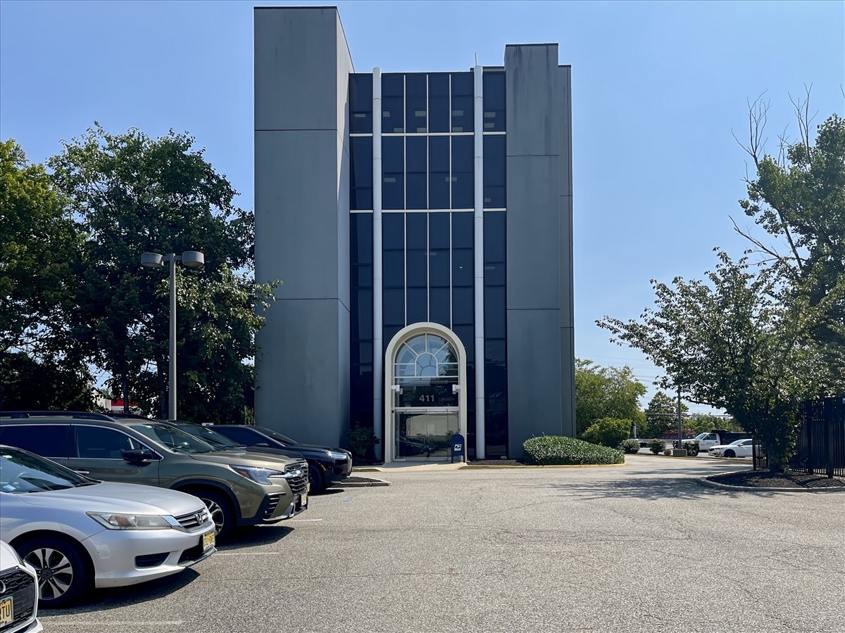 Exterior view of the modernist concrete facade at 411 State Route 17.