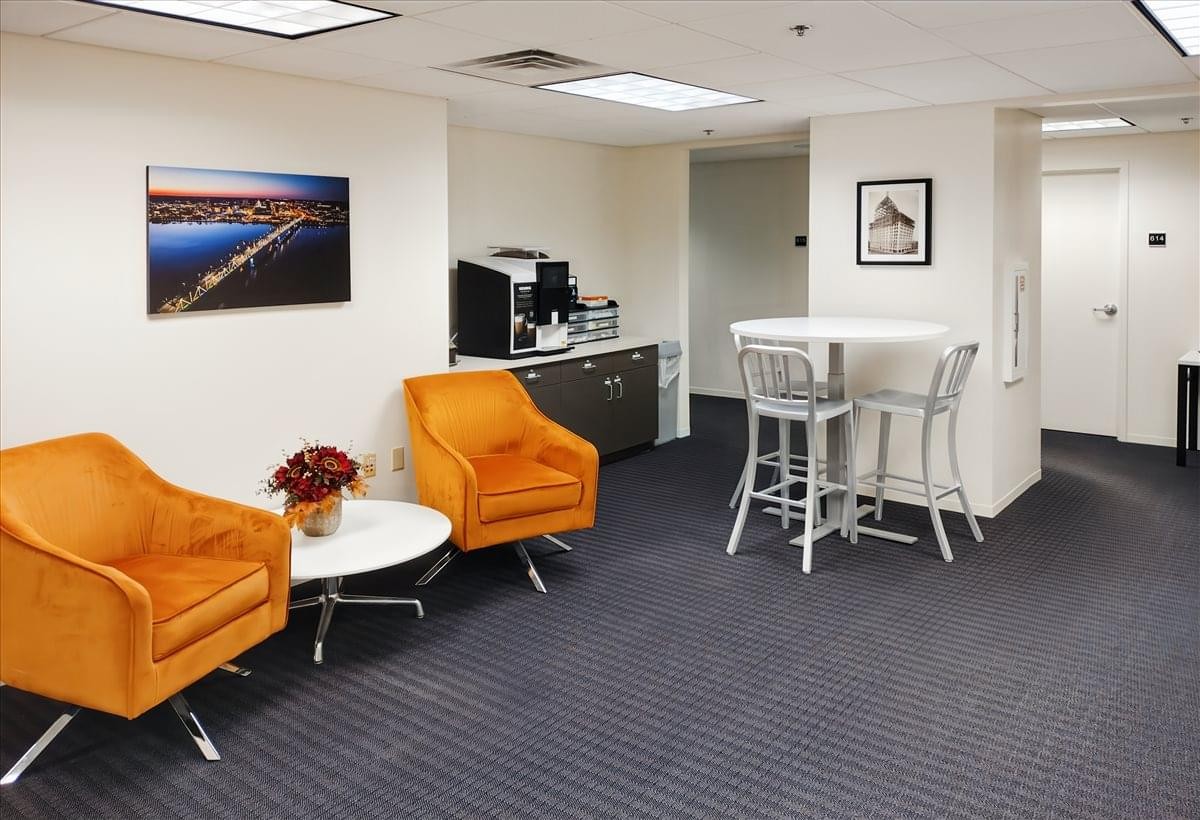 Lounge area with orange armchairs and coffee station at 416 Main Street, Suite 600, Peoria (IL), Illinois.