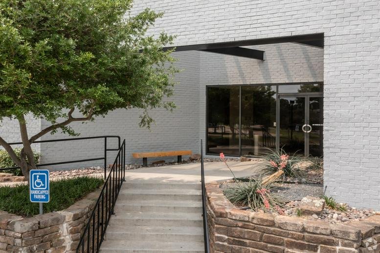 Exterior view of the white brick building at 4201-4225 Wingren Drive showing the main entrance.