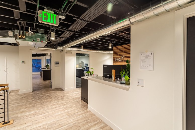Spacious reception area at 4260 East Evans Avenue with modern lighting and wood-paneled feature wall.
