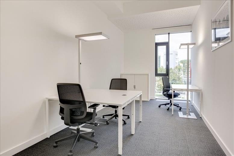Two-person private office with modern chairs and light-filled windows.