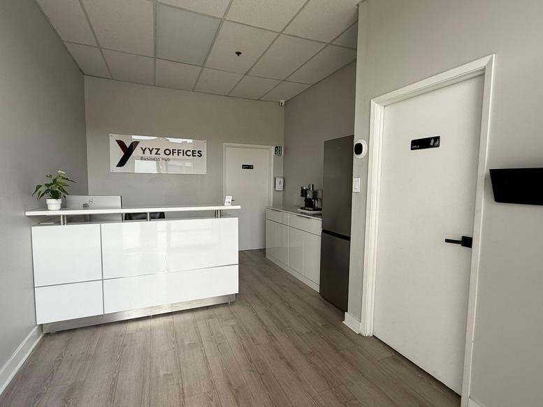 Bright reception area with a white desk and branded signage at 448, Gibraltar Drive, Unit 9.