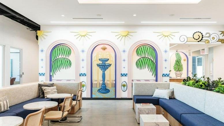 Spacious lounge at 448 North LaSalle Drive with vibrant wall murals, blue velvet seating, and potted plants.