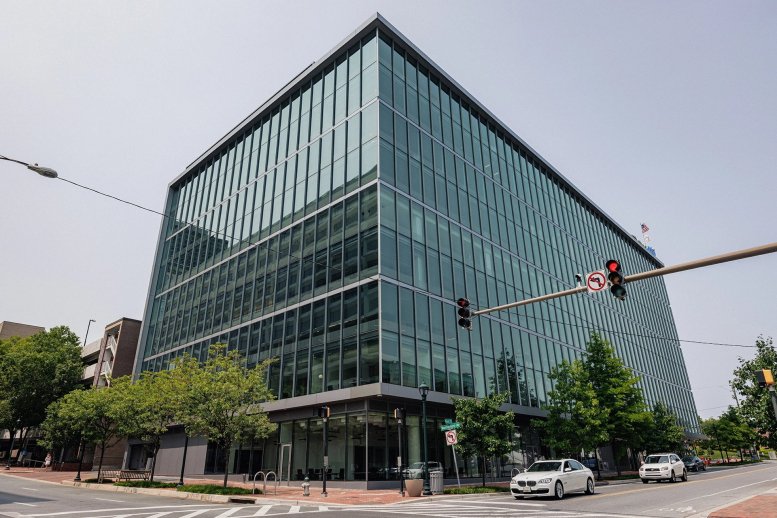 Exterior view of the glass-facade 4500 East West Highway building on a prominent street corner.