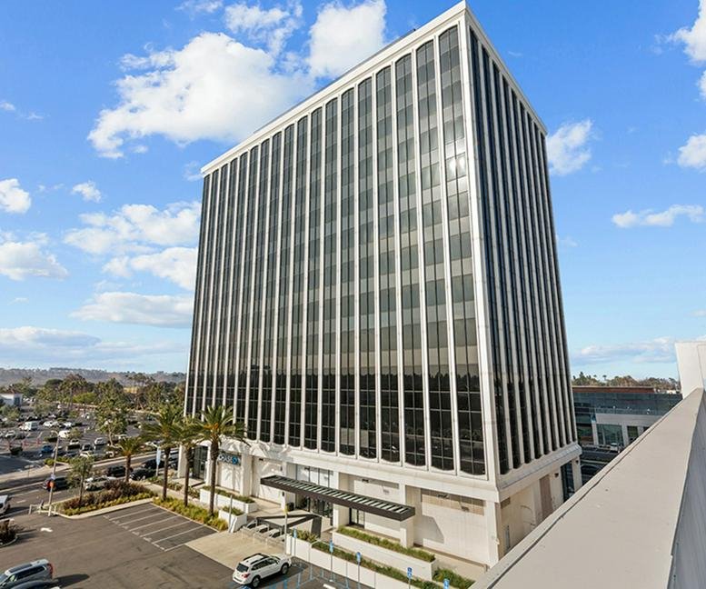 Exterior view of the multi-story office building at 4676 Admiralty Way under a blue sky.
