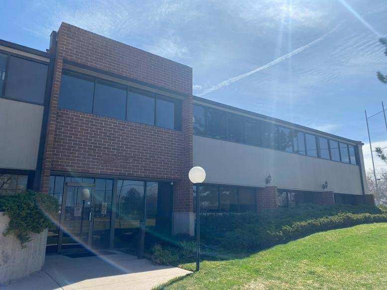 Exterior view of the brick and glass office building at 4770 East Iliff Avenue.