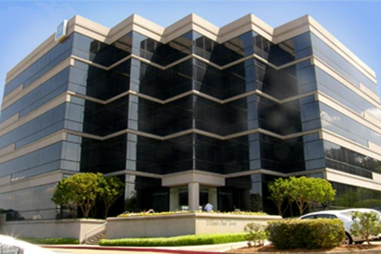 Modern glass and brick exterior of the 4780 I-55 N building with professional landscaping.