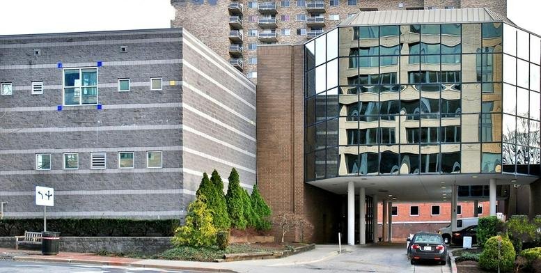 Exterior view of the brick and glass facade building at 4848 Battery Lane.