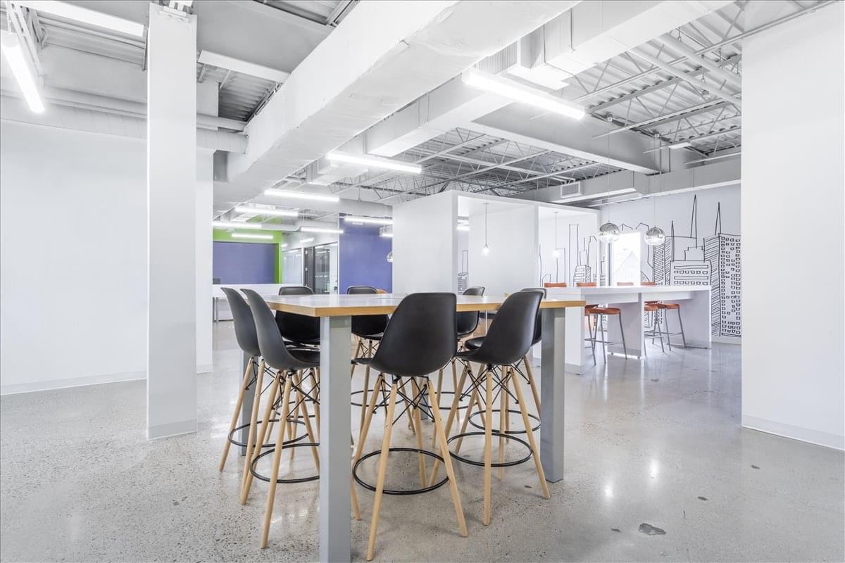 Spacious communal area at 49 High Street, 3rd Floor, featuring a high table and modern bar stools.