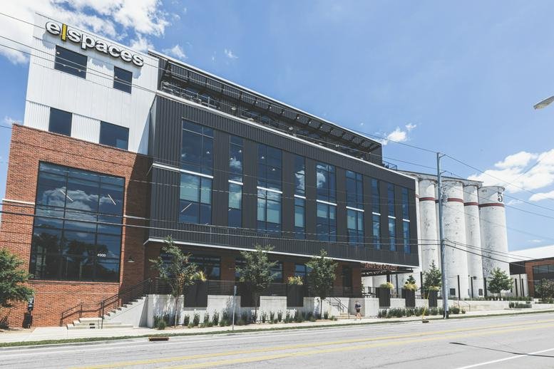 Exterior view of the modern brick and glass building at 4900 Centennial Boulevard.