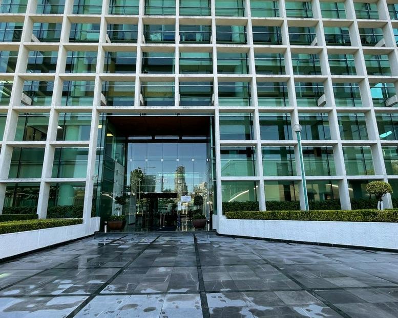 Glass facade entrance of the office building at 50, Alfonso Nápoles Gándara, Mexico City.