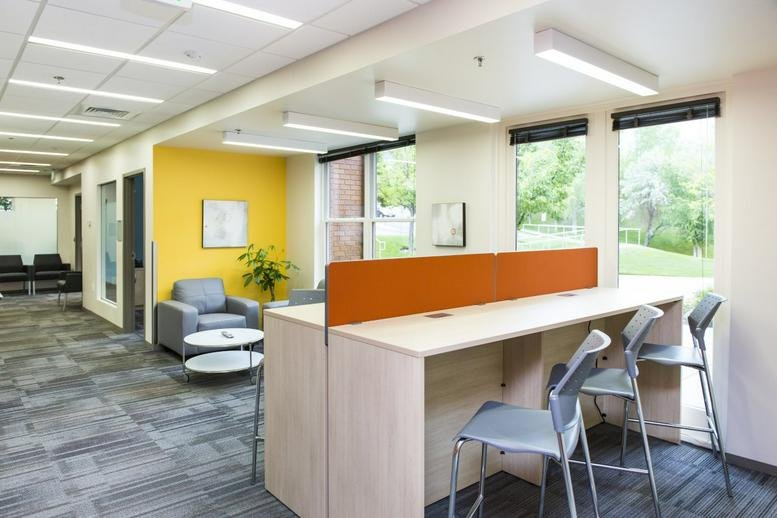 Spacious coworking area at 50 Iron Point Circle, Suite 140, Folsom (California) with a yellow feature wall.