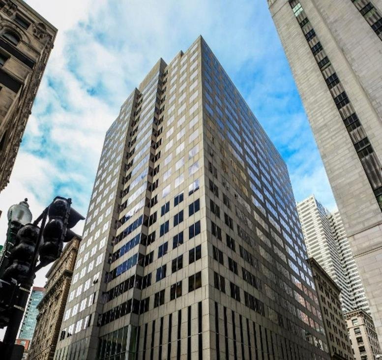 Exterior view of the multi-story stone and glass building at 50 Milk Street.