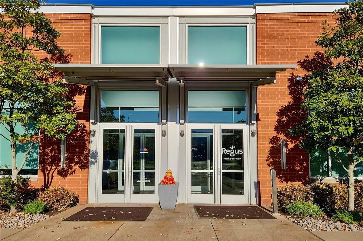 Exterior entrance at 50 Pennwood Place, Suite 200 with brick facade and glass double doors.