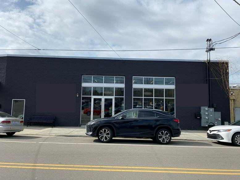 Exterior view of the dark grey industrial facade at 506 Ramseur Street, Suite 1.