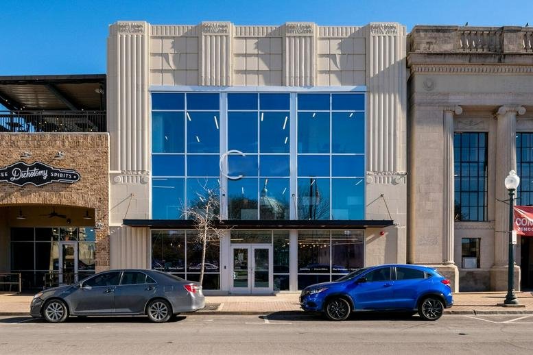 Exterior facade of the Executive Center, 510 Austin Avenue, featuring a blue glass-tiled front.