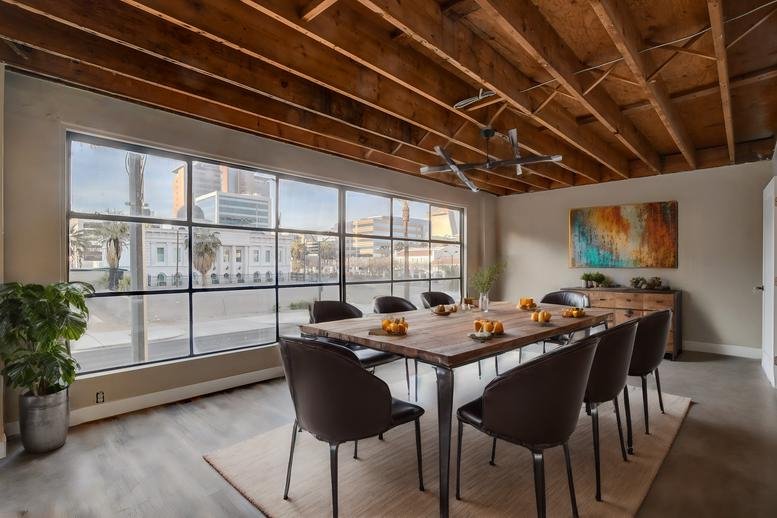 Spacious boardroom at 511 S Las Vegas Blvd with industrial ceilings and a large wooden table.