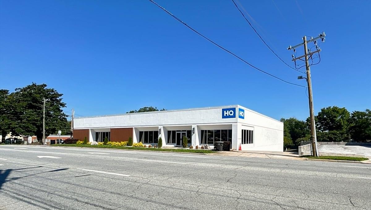 Exterior view of the white and brick building at 516 W Friendly Avenue.
