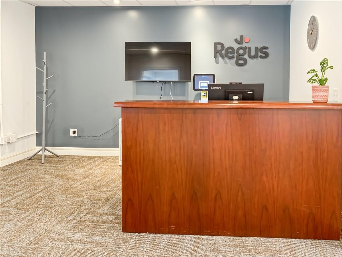 Branded reception area at 5360 Genesee Street, Suite 203, Bowmansville, New York with wooden desk and feature wall.