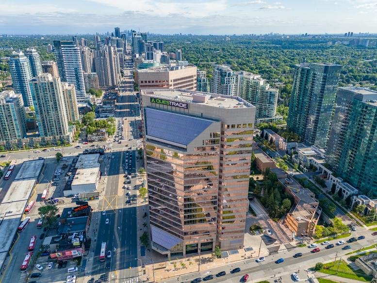 Aerial view of the modern reflective glass and stone facade of 5700 Yonge Street.
