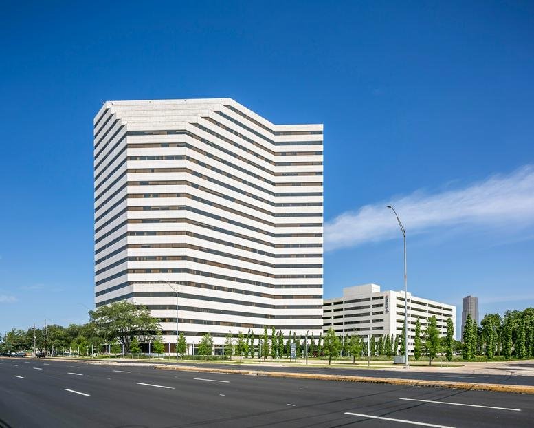 Exterior view of the white tiered-facade building at WorkSuites Westheimer.