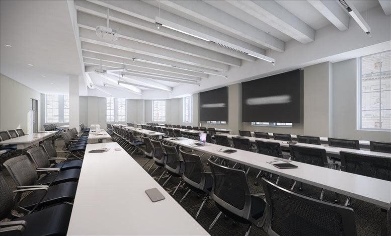 Large contemporary training room at 600 14th Street NW, Washington DC with long white tables and black chairs.