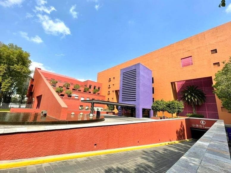 Exterior view of the colorful orange and purple building at 600, Calle Guillermo Haro, Santa Fe, Mexico City.