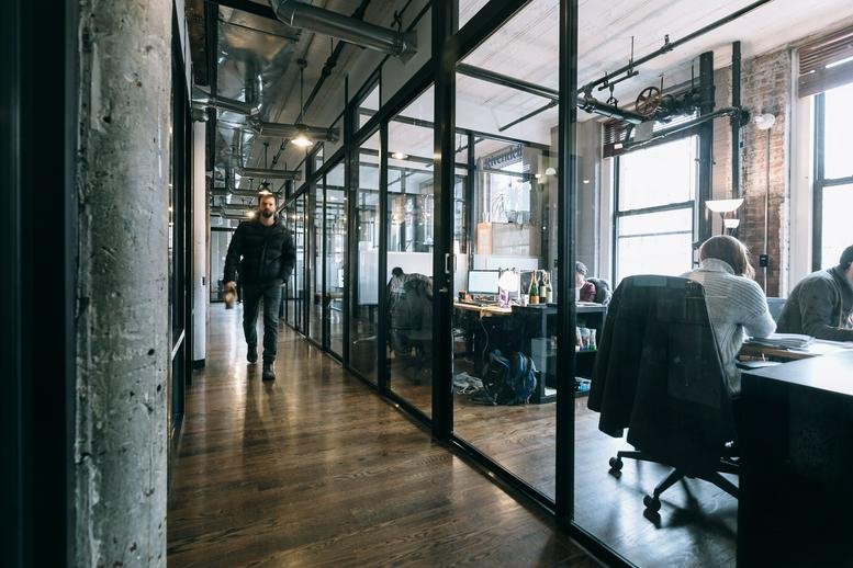 Industrial-style corridor with glass-walled offices at 6060 Silver Drive, Metrotown.