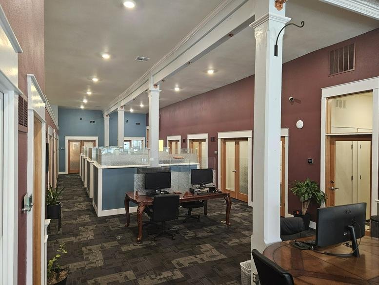 Spacious open-plan office at 609 East Main Street with high ceilings and rows of workstations.