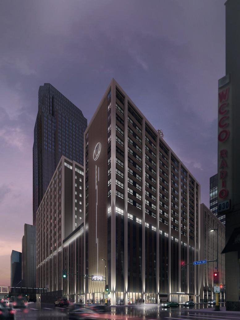 Exterior view of the lit modern skyscraper at 625 S Marquette Avenue at dusk.