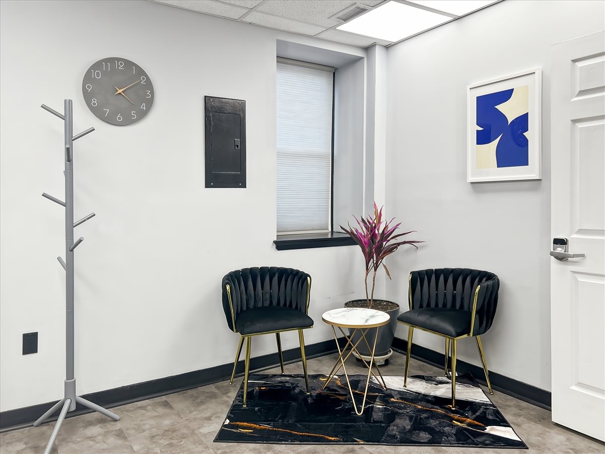 Lounge area at 63 New Main Street, 1st Floor, Haverstraw with velvet chairs and a potted plant.