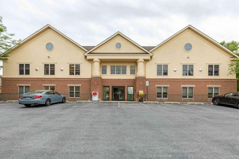 Exterior view of the gabled brick and beige facade at 6339 Ten Oaks Road, Suite 200, Clarksville (Maryland).