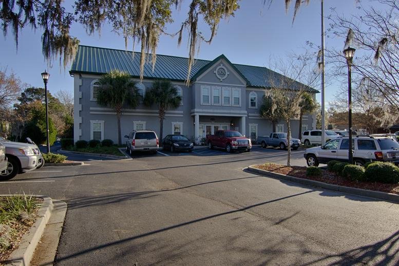 Exterior view of the grey building and parking lot at 6650 Rivers Avenue, North Charleston.