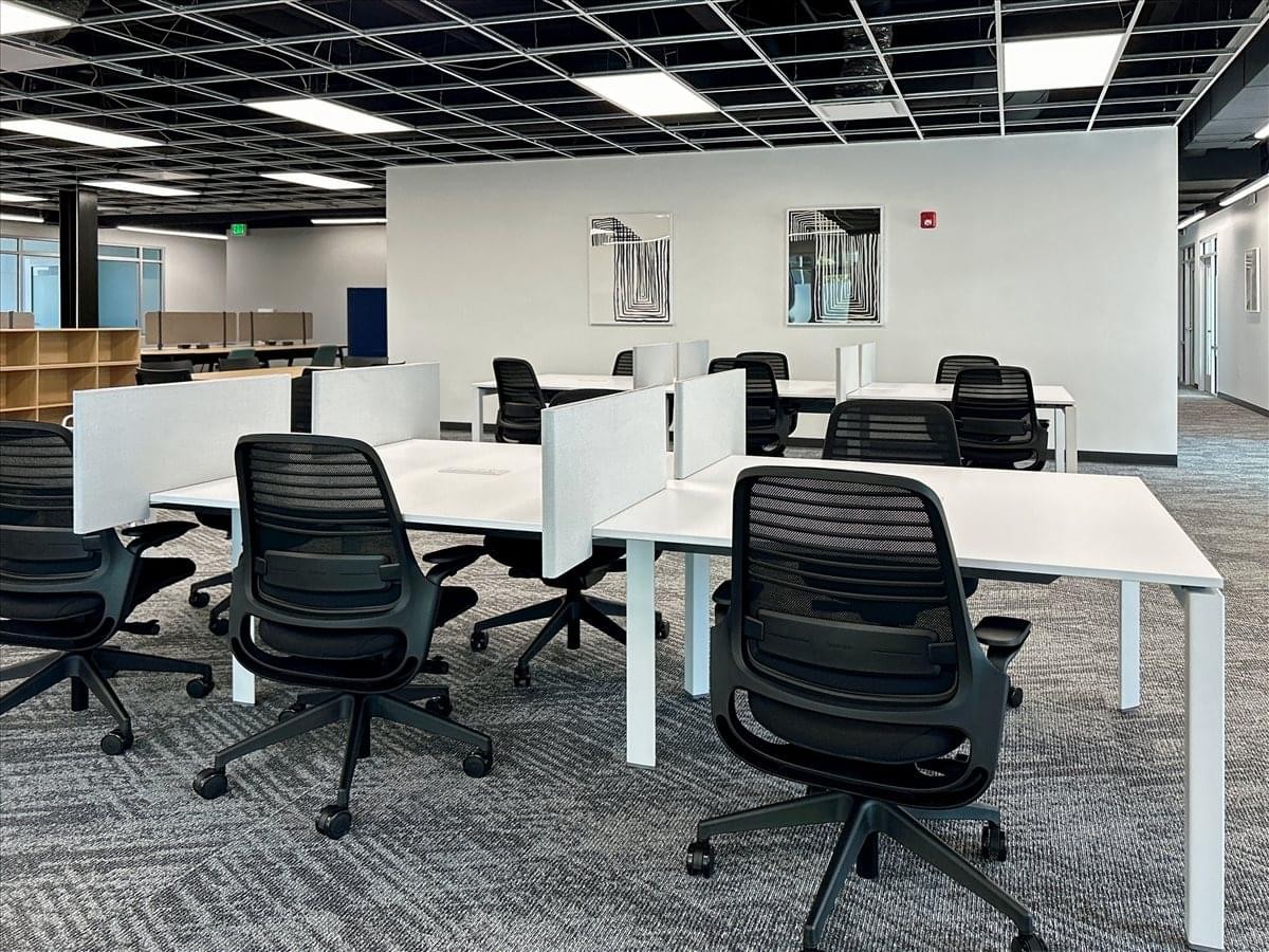 Spacious open-plan workspace at 701 South Main Street, 1st Floor, Logan (UT) with rows of desks and ergonomic chairs.